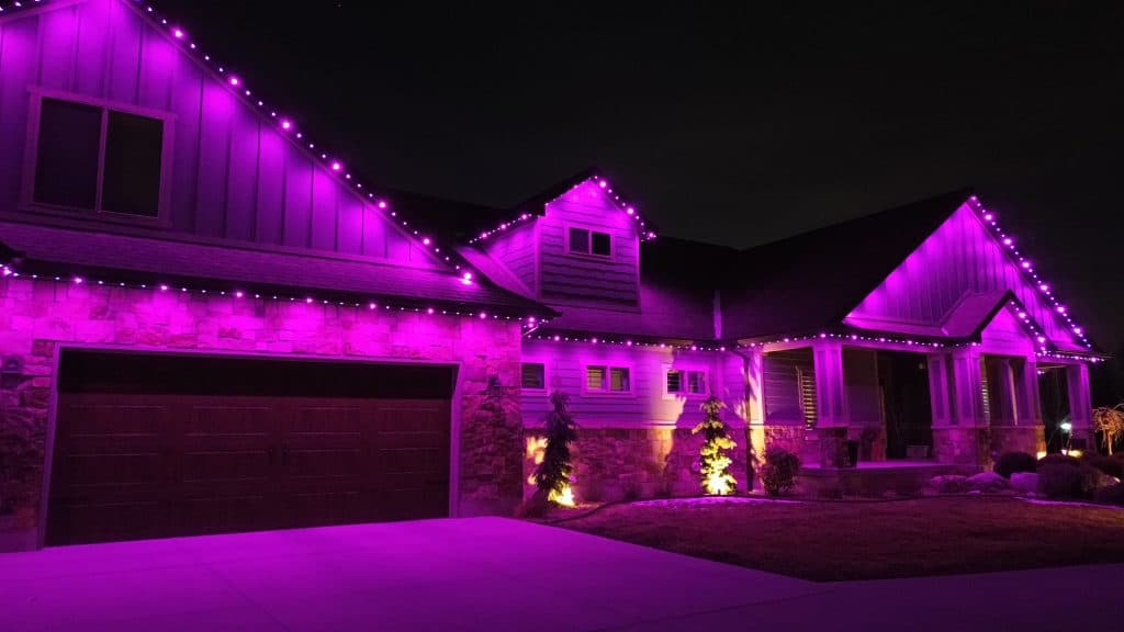TruLight manufacturer example: Wide aerial view of home with permanent LED lighting at night