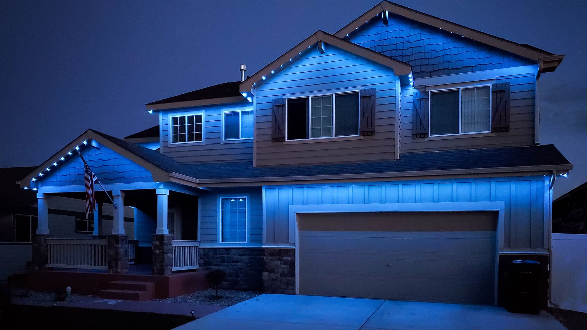 TruLight manufacturer example: Wood siding home with cool white LED roofline lighting